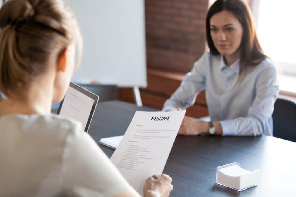 Two people talking across a desk during a career conversation